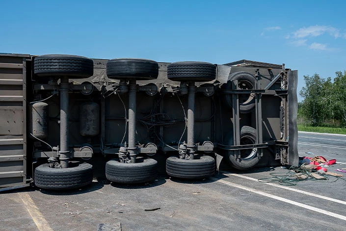 A semitruck is overturned on a Wyoming highway in a crash requiring the help of a commercial truck accident lawyer.
