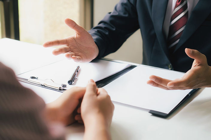 An attorney talking with a client who needs to know the answer to the question: “Does Wyoming have a helmet law?”