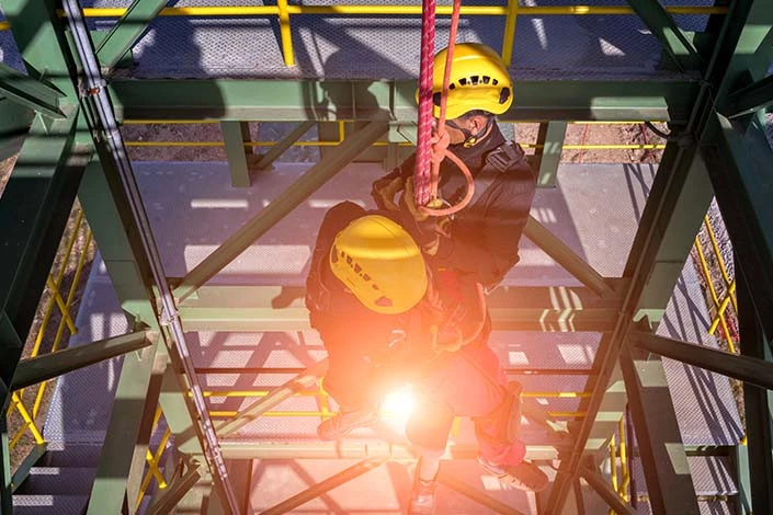 Rescue team descending a shaft after fatal industrial accidents