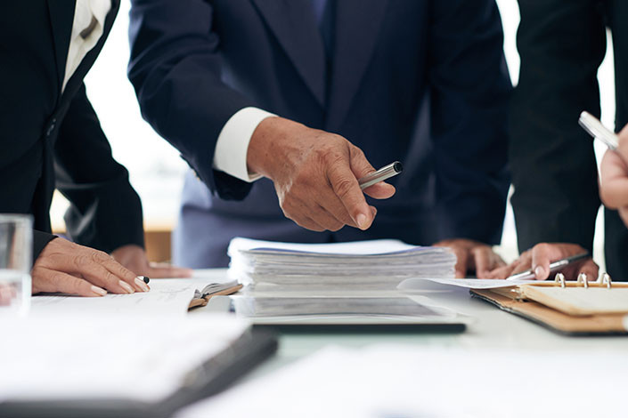 A work accident attorney’s staff reviews a case.